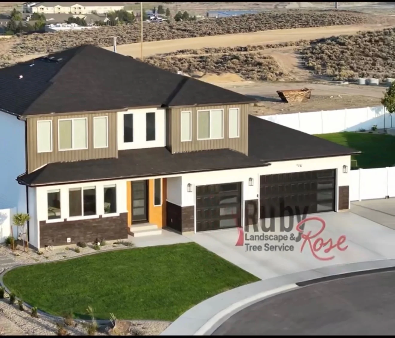 Front-yard lawn and planted approach to a home, with the original Ruby Rose watermark.